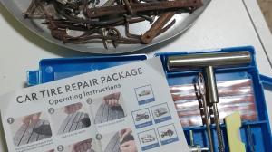 El kit de reparación y algunos de los clavos encontrados en la carretera