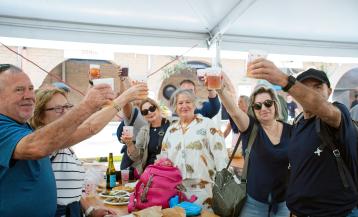 Vecinos celebrando en la carpa gastronómica