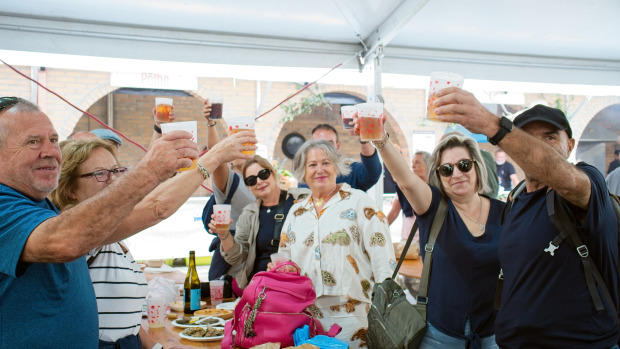 Vecinos celebrando en la carpa gastronómica